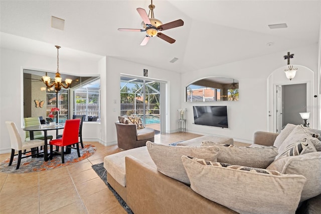 tiled living room with ceiling fan with notable chandelier and vaulted ceiling