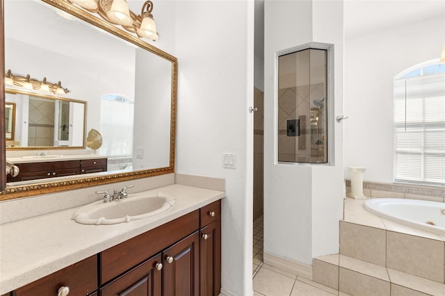 bathroom featuring vanity, tile patterned flooring, and shower with separate bathtub