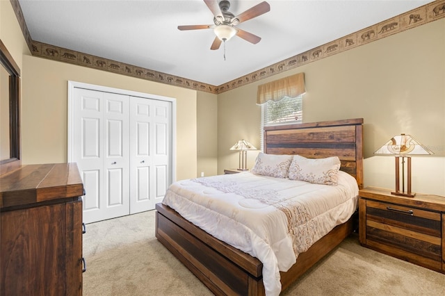 carpeted bedroom featuring ceiling fan and a closet