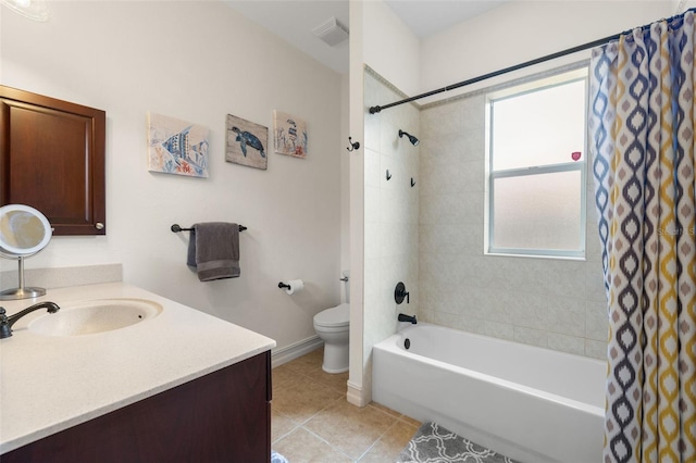 full bathroom with tile patterned floors, toilet, vanity, and shower / bath combo with shower curtain