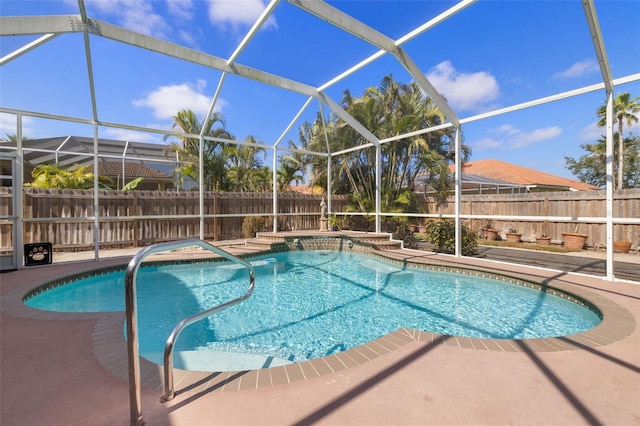 view of pool featuring a patio area and glass enclosure