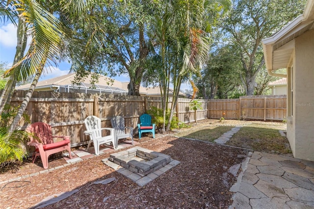 view of yard featuring an outdoor fire pit and a patio