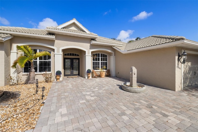 view of exterior entry featuring french doors