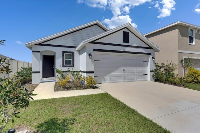 ranch-style home featuring a garage, concrete driveway, fence, and stucco siding