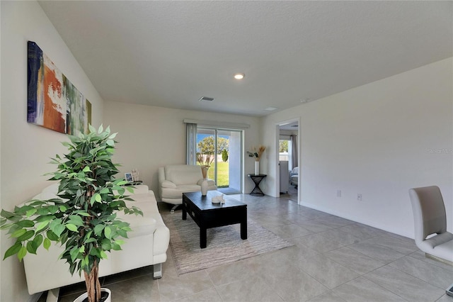 living room with light tile patterned floors and visible vents