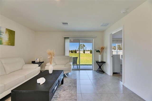 living room with baseboards, visible vents, and light tile patterned flooring