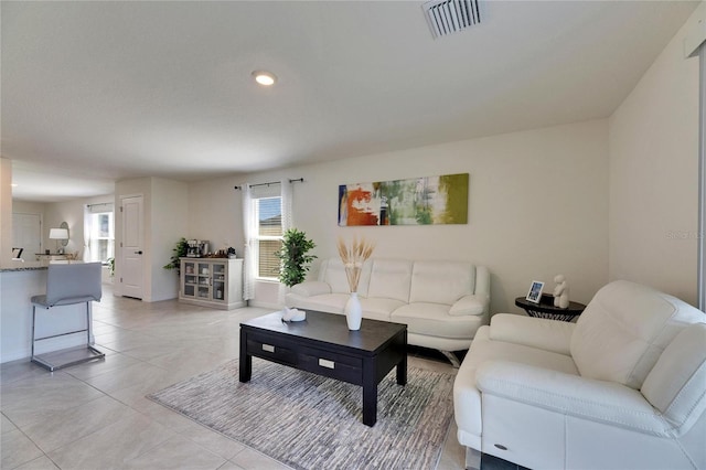 living room featuring light tile patterned floors, recessed lighting, visible vents, and a healthy amount of sunlight