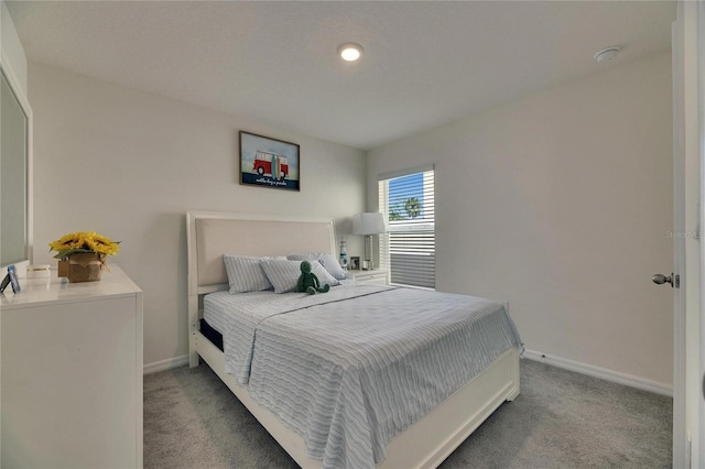 bedroom featuring carpet floors and baseboards