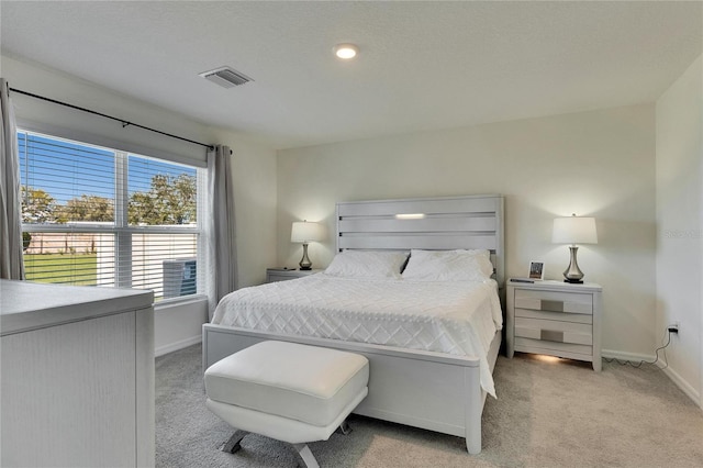 bedroom featuring light carpet, visible vents, and baseboards