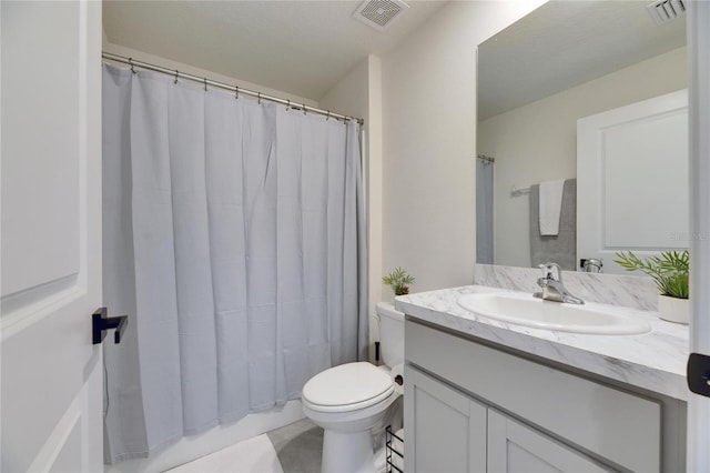 bathroom with visible vents, vanity, and toilet