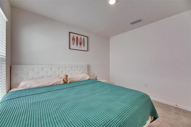 unfurnished bedroom with carpet flooring, visible vents, baseboards, and multiple windows