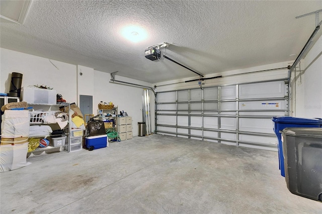 garage with a garage door opener and electric panel