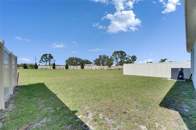 view of yard with cooling unit, a rural view, and fence