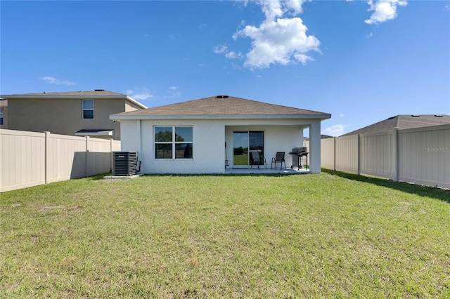 back of property featuring a lawn, a fenced backyard, central air condition unit, a patio area, and stucco siding