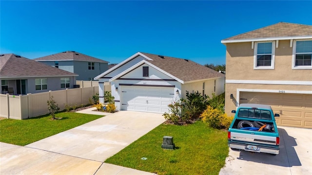 view of front of home with fence, driveway, a front lawn, and stucco siding