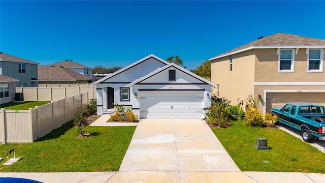 view of front of property with a garage, fence, driveway, stucco siding, and a front lawn