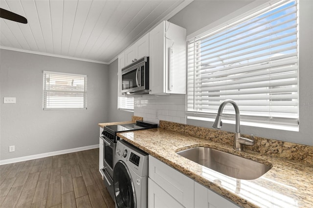 kitchen with light stone counters, a sink, white cabinetry, electric range oven, and stainless steel microwave