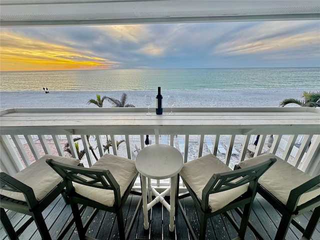 balcony with a water view and a beach view