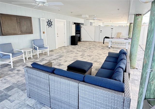 interior space featuring ceiling fan and stone finish floor
