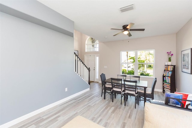 dining space with light wood finished floors, visible vents, a healthy amount of sunlight, and baseboards