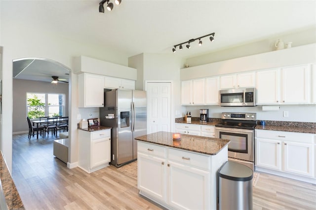 kitchen with ceiling fan, white cabinets, light wood-type flooring, and stainless steel appliances