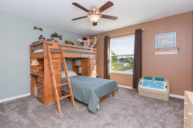 carpeted bedroom featuring a ceiling fan and baseboards