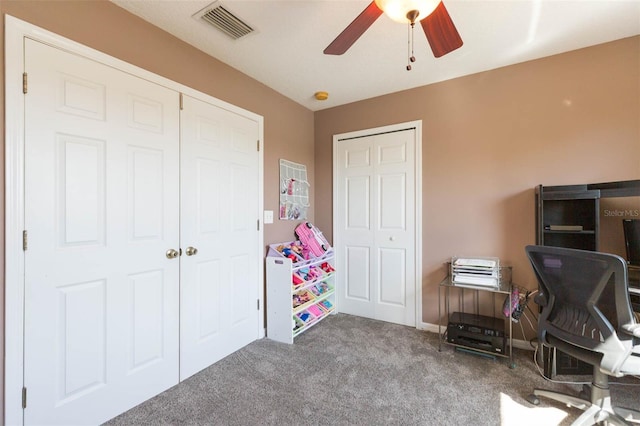 home office featuring visible vents, carpet, and ceiling fan