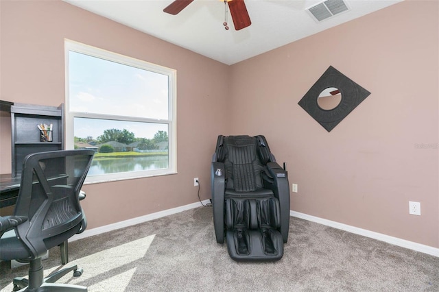 office area with a ceiling fan, baseboards, visible vents, carpet floors, and a water view