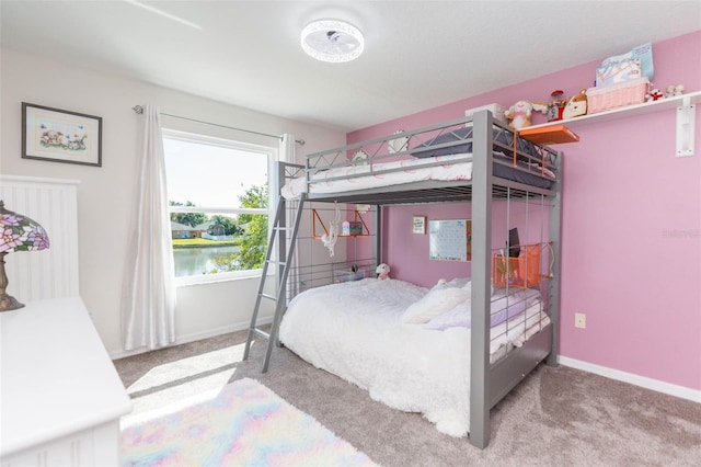 bedroom featuring baseboards and carpet