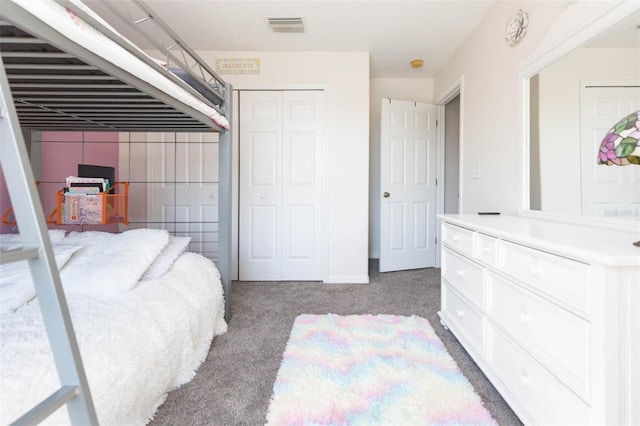 carpeted bedroom featuring visible vents and a closet