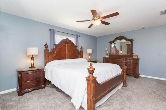 bedroom with light colored carpet, baseboards, and ceiling fan