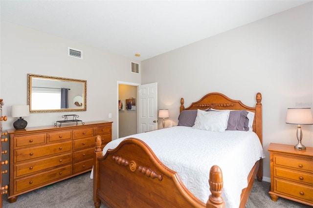 carpeted bedroom featuring visible vents