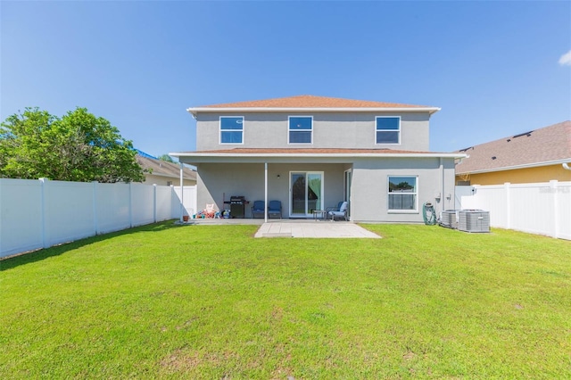 rear view of property with a patio area, a lawn, a fenced backyard, and stucco siding