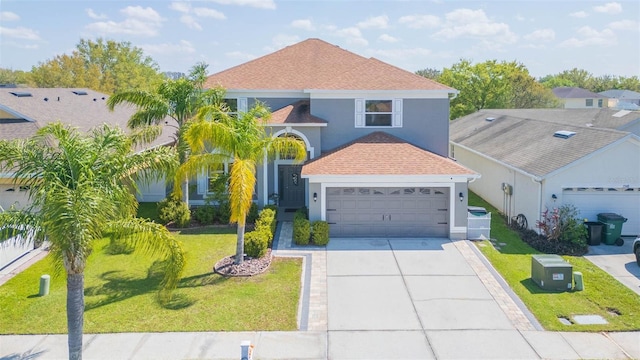 traditional home featuring a front yard, roof with shingles, stucco siding, concrete driveway, and a garage