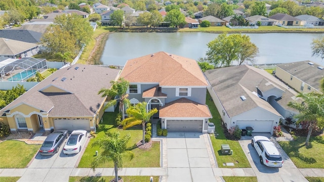 drone / aerial view with a residential view and a water view