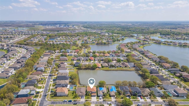 drone / aerial view featuring a residential view and a water view