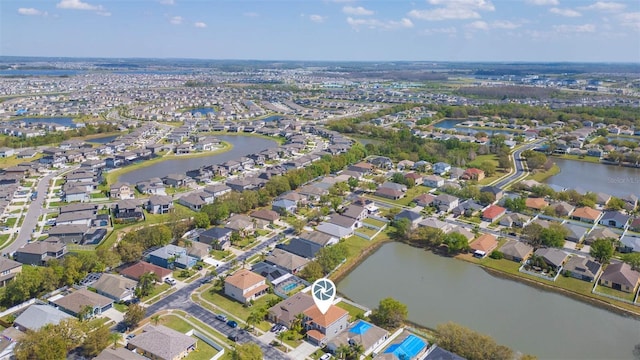 drone / aerial view featuring a residential view and a water view