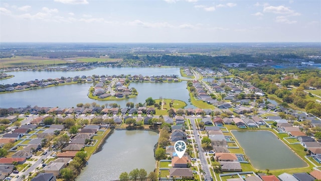 drone / aerial view featuring a residential view and a water view