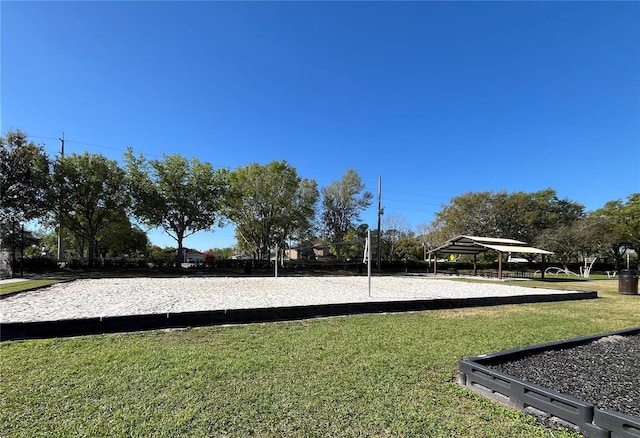 view of home's community featuring volleyball court and a lawn