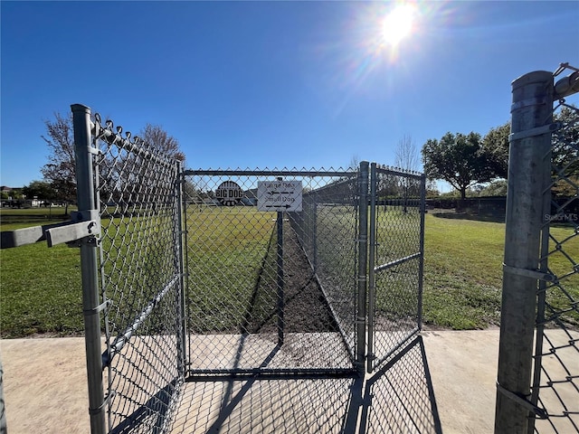 view of gate featuring a yard and fence