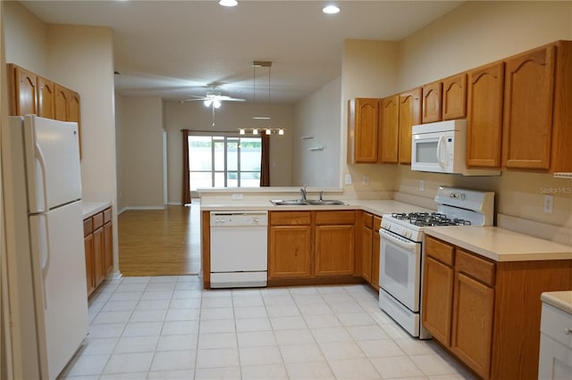 19432 Haskell Pl, Land O Lakes, FL 34638 - kitchen featuring white appliances, brown cabinetry, light countertops, recessed lighting, and ceiling fan