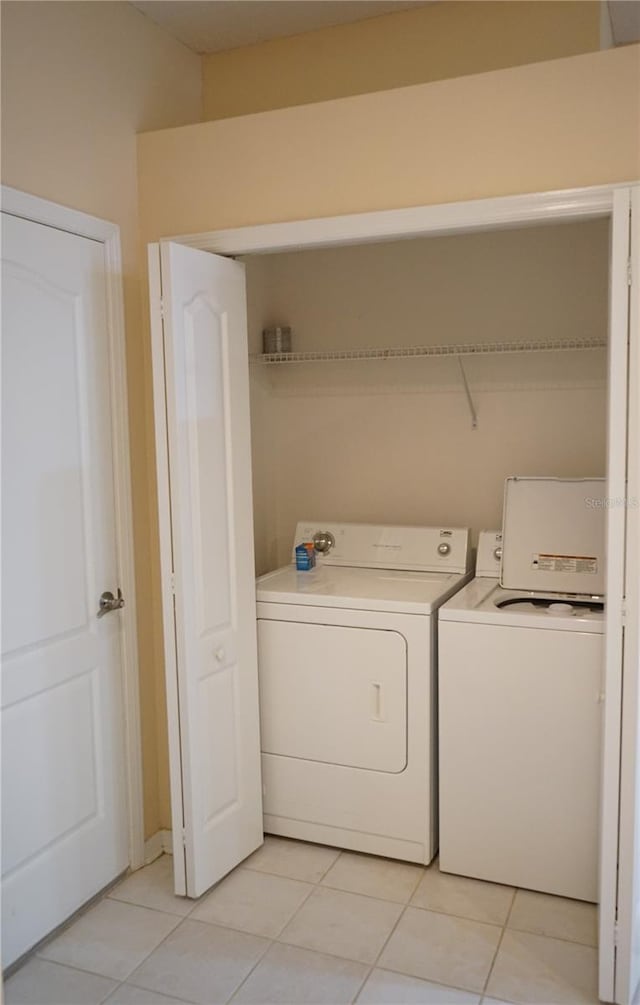 19432 Haskell Pl, Land O Lakes, FL 34638 - washroom featuring washer and clothes dryer and light tile patterned flooring