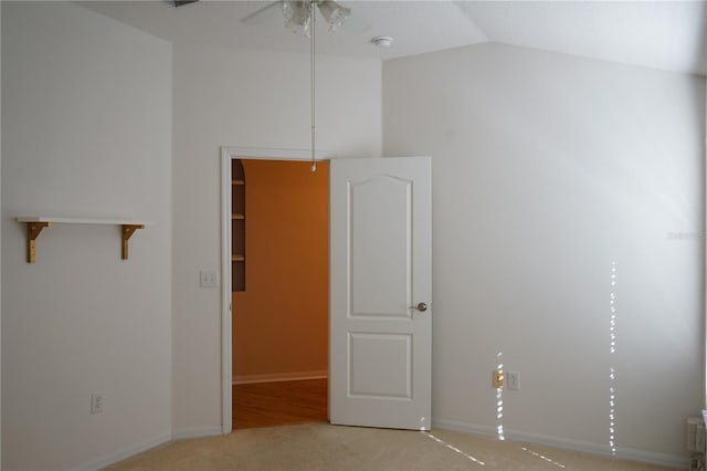 19432 Haskell Pl, Land O Lakes, FL 34638 - empty room with vaulted ceiling, a smoke detector, carpet flooring, and a ceiling fan