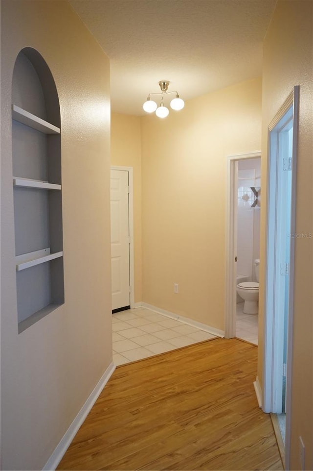 19432 Haskell Pl, Land O Lakes, FL 34638 - corridor with light wood finished floors and a chandelier