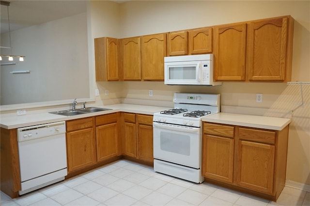 19432 Haskell Pl, Land O Lakes, FL 34638 - kitchen with white appliances, a peninsula, light countertops, and brown cabinets