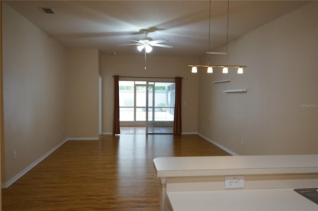 19432 Haskell Pl, Land O Lakes, FL 34638 - unfurnished room featuring wood finished floors and ceiling fan