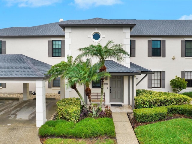 view of front of property featuring a shingled roof and stucco siding