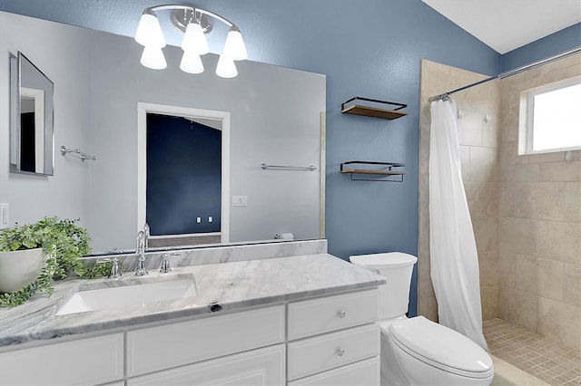 full bath with a shower stall, vanity, and toilet