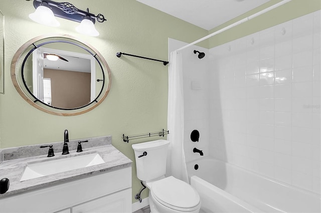 bathroom featuring a textured wall, tub / shower combination, vanity, and toilet