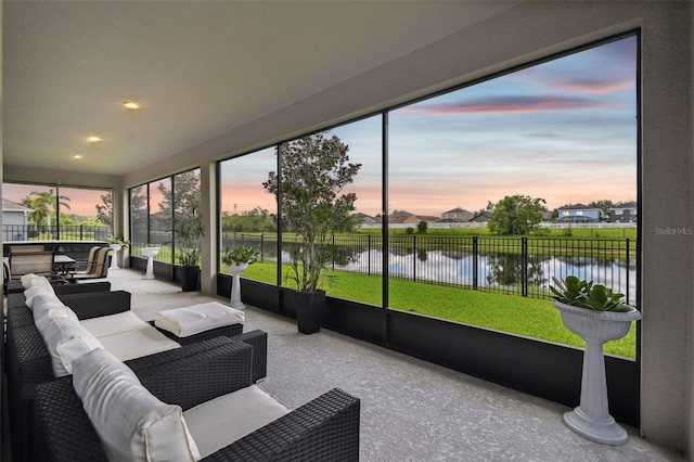 sunroom / solarium with a water view